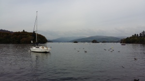 Image of a yacht on lake Windermere with misty mountains 